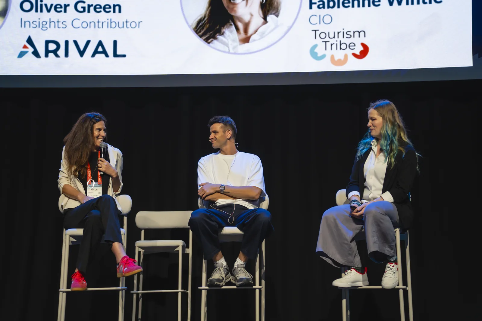 Fabienne Wintle, mic in hand, on the Arival 360 Brisbane main stage alongside Arival's Oliver Green during the Live AI Build session