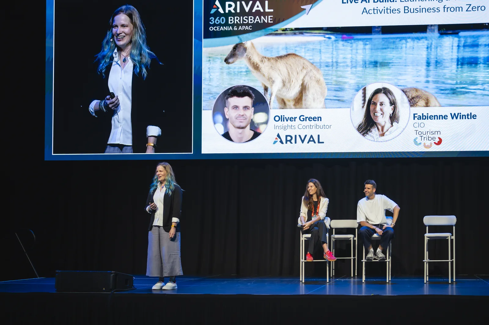 Wide view of the Live AI Build session on the Arival 360 Brisbane main stage, the session title on screen